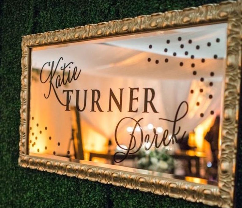 A mirror with the text “Katie and Derek Turner”