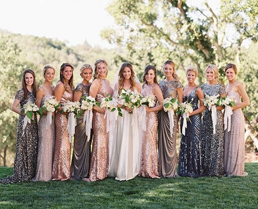Bride with bridesmaids holding flower bouquets