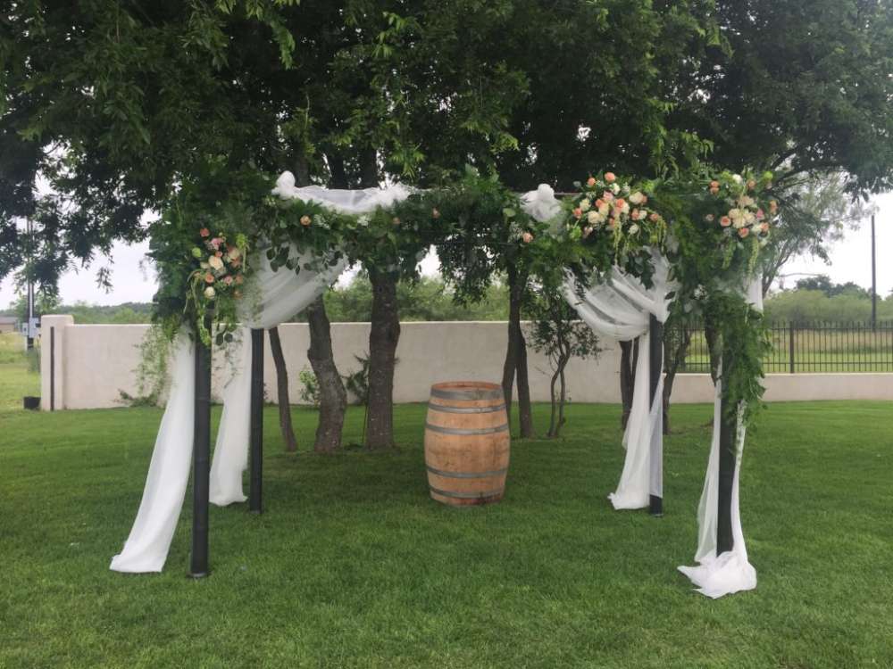 Outdoor wedding set up trees decorated with flowers